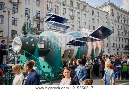 MOSCOW, RUSSIA - SEP 10, 2017: People near model of space lab Salute and cosmonaut on Tverskaya Street during celebration 870th anniversary of Moscow.