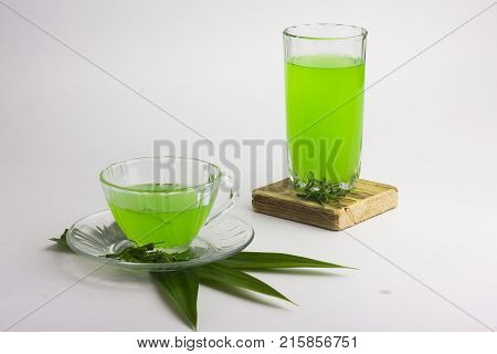 Glass Of Cold Pandan Juice - Healthy Food Against Wood,.with Pandan Green.on A White Background