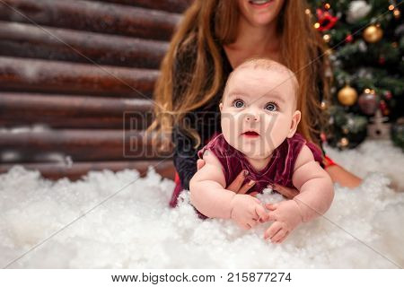 Newburn plays with his mother in artificial snow