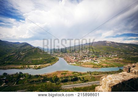 View on Mtskheta, one of the oldest cities of Georgia, from Jvari Monastery. Confluence of the Mtkvari and Aragvi rivers with visible color difference. 