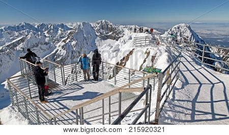 LOMNICKY STIT SLOVAKIA - FEBRUARY 27: People on the top of the hill Lomnicky peak in High Tatras mountains on February 27 2013 in Lomnicky stit
