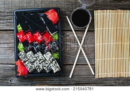 Sushi In A Black Container On A Wooden Table Colorful And Beautiful