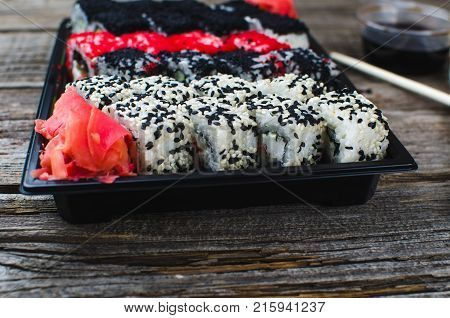 Sushi In A Black Container On A Wooden Table Colorful And Beautiful