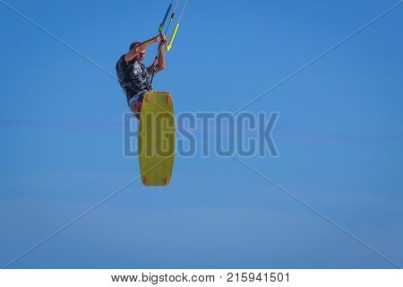 Young Atletic Man Riding Kite Surf On A Sea