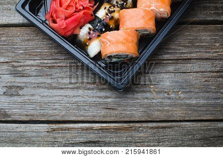 Sushi In A Black Container On A Wooden Table Colorful And Beautiful
