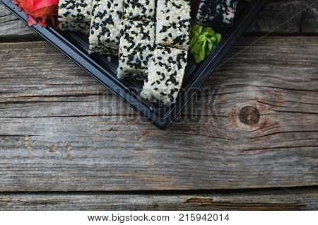 Sushi In A Black Container On A Wooden Table Colorful And Beautiful