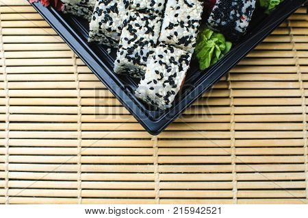 Sushi In A Black Container On A Wooden Table Colorful And Beautiful