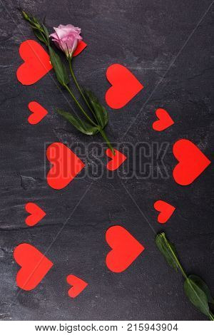 The hearts are lined up in one big heart lying vertically. With Japanese roses in the form of an arrow passing through the heart on a stone background