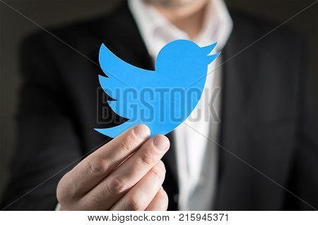 JYVASKYLA FINLAND - JUNE 13 2017: Close up of man in a suit showing printed Twitter logo. Twitter is a social media network that was founded in 2006. Illustrative editorial.