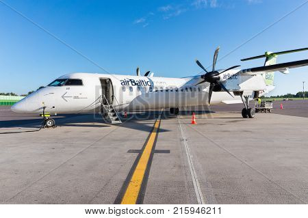 RIGA LATVIA - AUGUST 27 2016: AirBaltic airplane after landing in the airport of Riga. Airbaltic is a latvian low-cost carrier and airline. Editorial.