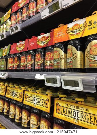 Waterloo, Belgium - November 28, 2017: Belgian beer on the shelf. Six-packs of Grimbergen beer on the grocery store shelf.