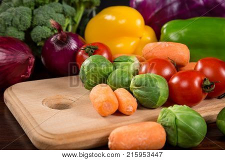Assortment of fresh vegetales on cutting board, healthy nutrition background