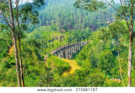 The winding tall Nine Arches Bridge is one of the most popular sites of Ella tourists come here and wait the trains Demodara Sri Lanka.