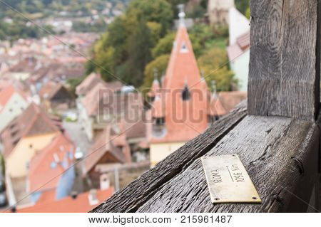 Sighisoara Romania October 08 2017 : Pointer - Rome 1096 Km - nailed to the railing of the Clock Tower in the castle of old city. Sighisoara city in Romania