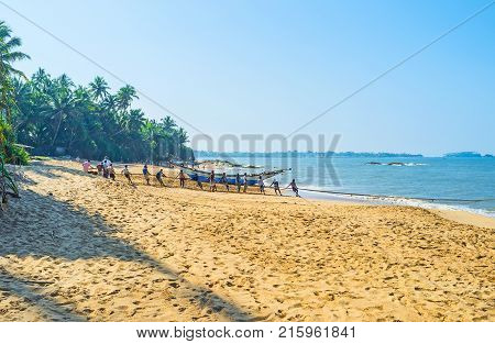 BENTOTA SRI LANKA - DECEMBER 6 2016: The comfortable beaches of Ceylon are famous among the foreign tourists and local fishermen on December 6 in Bentota.