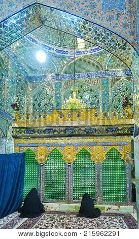 YAZD IRAN - OCTOBER 17 2017: Beautiful interior of Shahzade Fazel Holy Shrine with women praying in front of the tomb on October 17 in Yazd