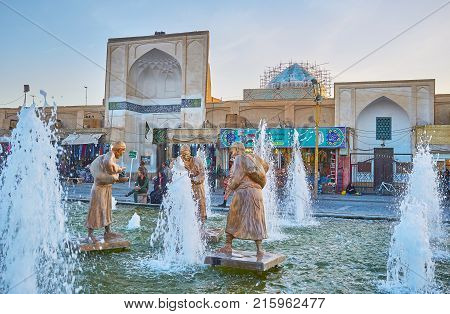 YAZD IRAN - OCTOBER 17 2017: The sculptures of water carriers located in the fountain in Amir Chakhmaq square on October 17 in Yazd