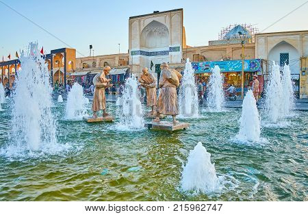 YAZD IRAN - OCTOBER 17 2017: Fountain in Amir Chakhmaq square with beautiful bronze sculptures attract tourists on October 17 in Yazd