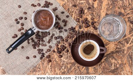 Coffee copper cup and water. Greek coffee with water and coffee pot. Turkish coffee and beans.