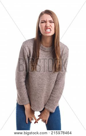 Young beautiful brunette girl showing an emotion of disgust, squirm face and showing teeth. Isolated on white background.