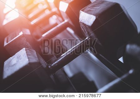 Dumbbells. Dumbbells stand in a row a toned photo with exposure for banner and site.
