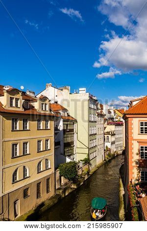 A boat travels down a canal in the Czech Republic capital of Prague