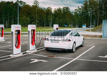 Tocksfors, Sweden- June 26, 2019: White Color Tesla Model S P85 Car Parked At Charging Station. The 
