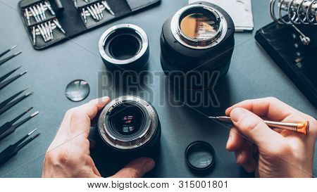Electronic Device Service. Top View Of Man Hands Repairing Photo Camera Optical Dslr Lens.