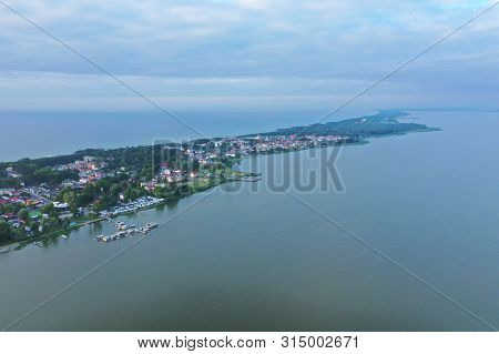 Drone Aerial Perspective View On Touristic City Located On Narrow Spit Between Sea And Lake.