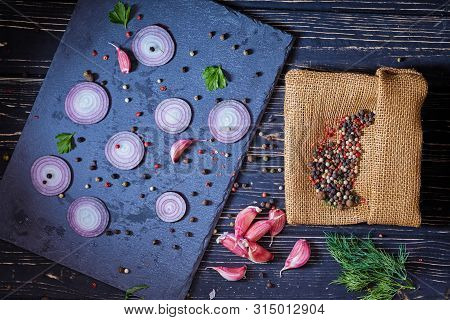 Pepper Peas Scattered Chaotically On The Board With Onions