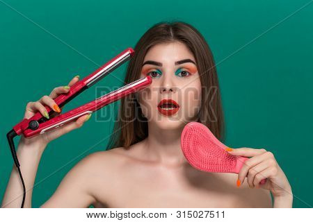 Portrait Of Surprised Beautiful Young Woman With Bright Color Make-up Doing Hair Style Herself With 