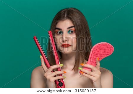 Portrait Of Surprised Beautiful Young Woman With Bright Color Make-up Doing Hair Style Herself With 