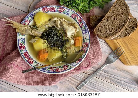 Ready Meals. Fish Soup In A Plate From Grouper (epinephelus Aeneus) On A Wooden Table Close-up