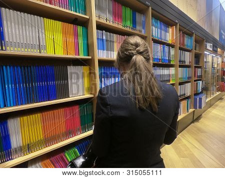 Dubai Uae - July 2019: Buyer Woman Selects File Folder In The Stationery Store. Buying New Office Su