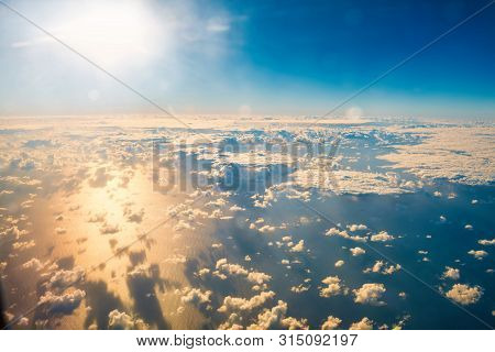 Beautiful Airview With Blue Sky, White Fluffy Clouds And Bright Sunrays Above Them. Can Be Used As N