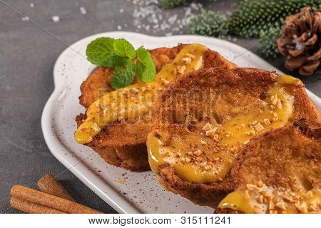 Traditional Christmas Rabanadas With Egg Yolk Crea And Cinnamon. Spanish Torrijas Close Up On The Co