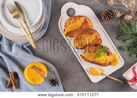 Traditional Christmas Rabanadas With Egg Yolk Crea And Cinnamon. Spanish Torrijas Close Up On The Co