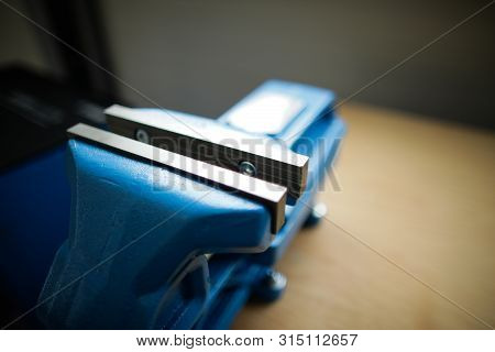 Shallow Depth Of Field Image With A Heavy Iron Vice On A Workbench Inside A Workshop With No People 