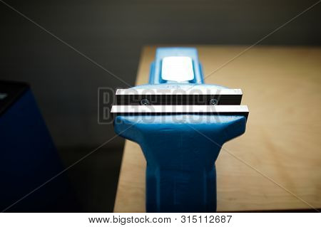 Shallow Depth Of Field Image With A Heavy Iron Vice On A Workbench Inside A Workshop With No People 