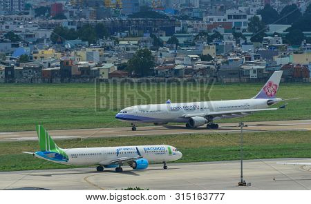 Saigon, Vietnam - Jul 13, 2019. Passenger Airplanes Taxiing On Runway Of Tan Son Nhat Airport (sgn) 