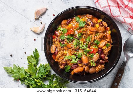 Chili Con Carne From Meat, Beans And Vegetables In Black Plate On Stone Table. Traditional Mexican F