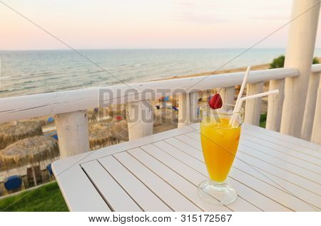 Vacation Drink Orange Juice With Strawberry View Of Sea. Perfect Vacation, Ready To Relax And Chill 