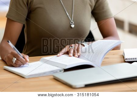 Close Up African Female Hands Holding Pen Make Notes