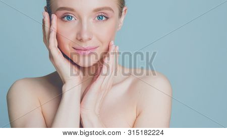 Portrait Of Beautiful Woman With Natural Make Up Touching Her Face.