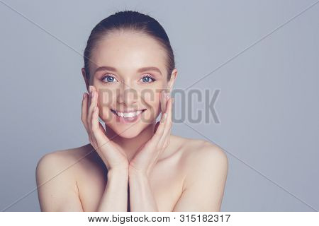 Portrait Of Beautiful Woman With Natural Make Up Touching Her Face.