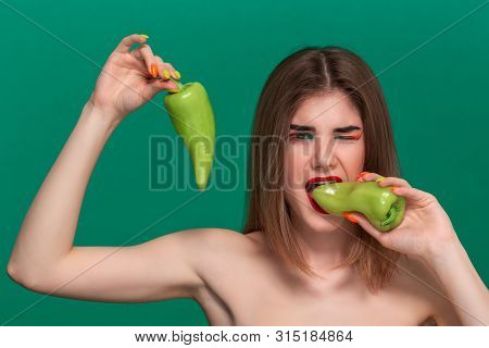 Closeup Portrait Of Beautiful Young Woman With Bright Color Make-up Holding Green Pepper Standing Is
