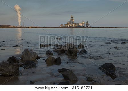 Editorial Aberavon, Uk - August 1, 2019: A Ship Unloading Its Cargo At Port Talbot Steel Works And A