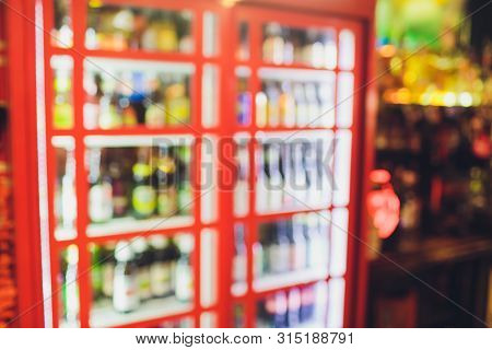 Blur Of Bottles Of Beer Alcohol Drink On Shelf In Supermarket Background.for Alcohol Drink Market Co
