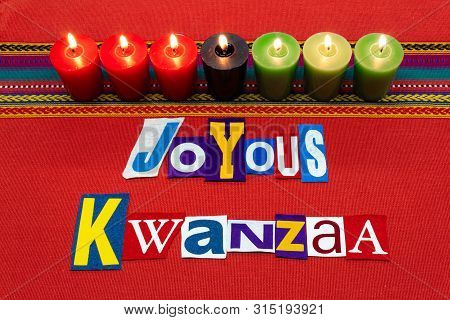 Joyous Kwanzaa Text Word Collage Typography, With Seven Candles And Multi Colored Fabric On Red Wove