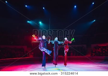 The Performance Of Stilt-walkers In The Circus